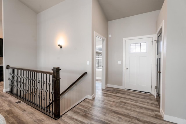 entryway featuring baseboards and wood finished floors