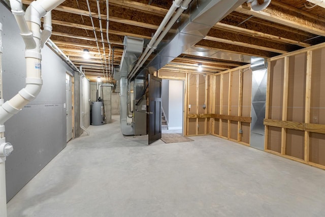 unfinished below grade area featuring heating unit, water heater, and stairway