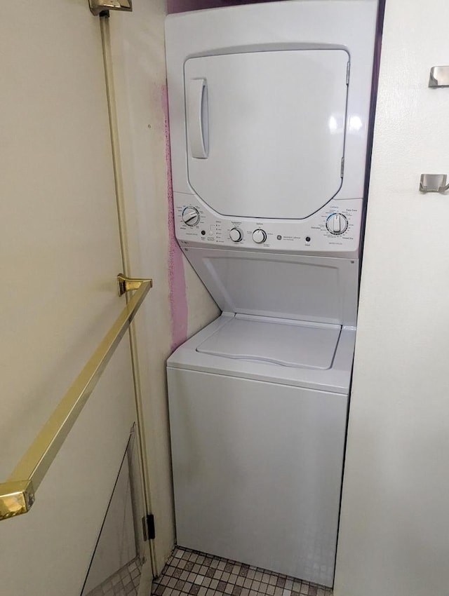 laundry room featuring laundry area and stacked washer / drying machine