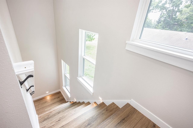 stairs with baseboards and wood finished floors