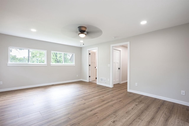 empty room with visible vents, baseboards, a ceiling fan, wood finished floors, and recessed lighting