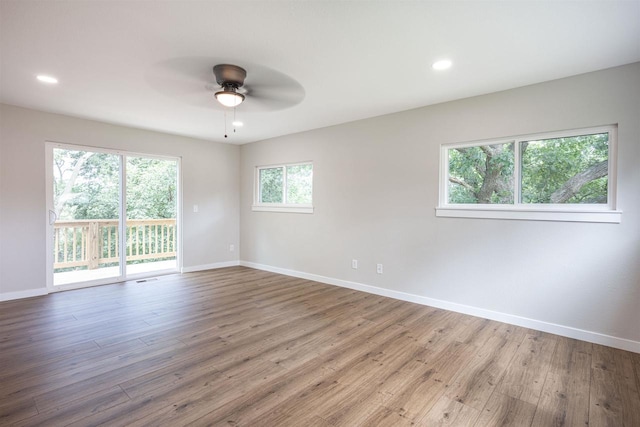 unfurnished room with a ceiling fan, recessed lighting, baseboards, and wood finished floors