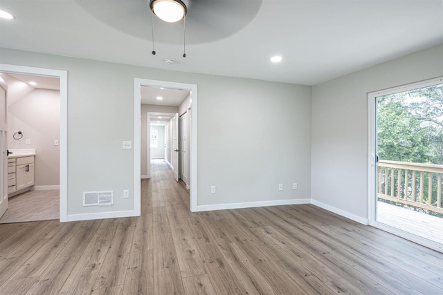 unfurnished bedroom with connected bathroom, recessed lighting, visible vents, baseboards, and light wood-type flooring