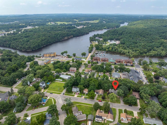 aerial view featuring a forest view and a water view