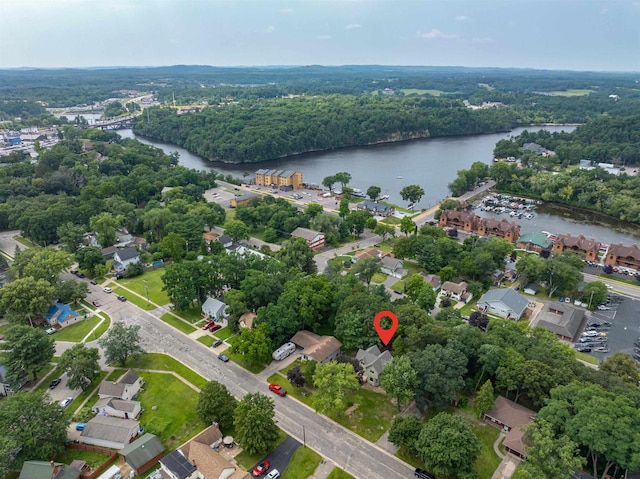 birds eye view of property with a water view and a view of trees