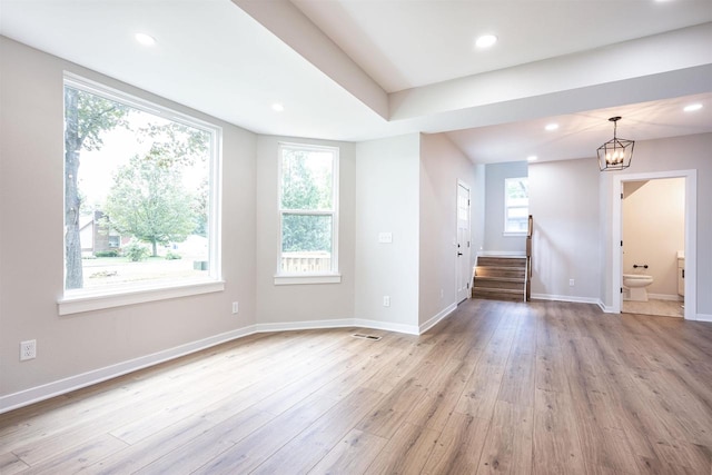 unfurnished room featuring light wood-style floors, stairway, baseboards, and recessed lighting