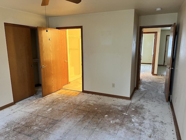 unfurnished bedroom with ensuite bath and baseboards