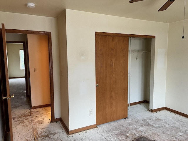 unfurnished bedroom with a ceiling fan, a closet, and baseboards