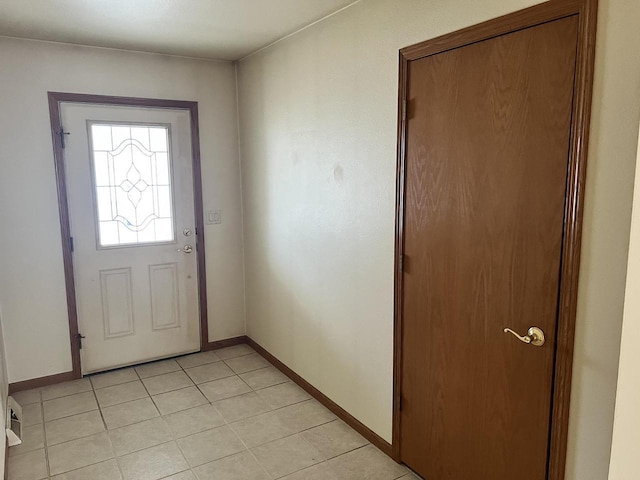 entryway featuring baseboards and light tile patterned flooring