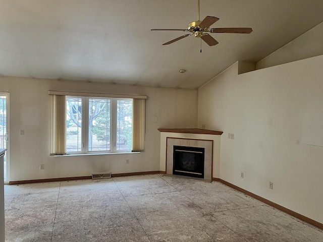 unfurnished living room with visible vents, a tiled fireplace, a ceiling fan, vaulted ceiling, and baseboards