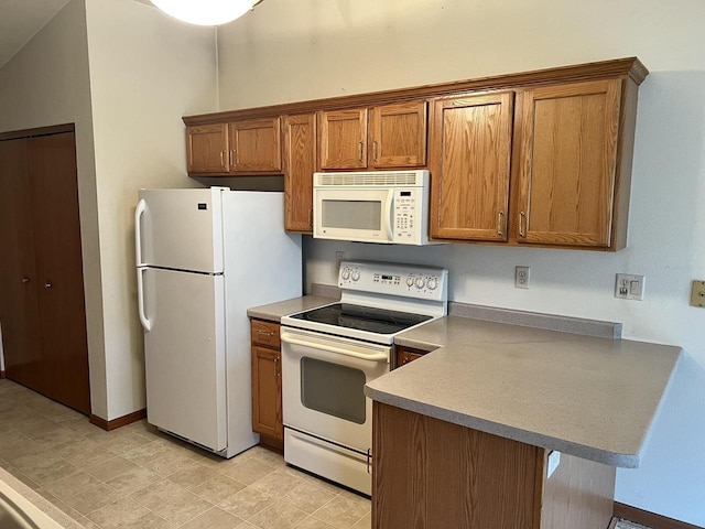 kitchen with brown cabinetry, white appliances, a peninsula, and baseboards