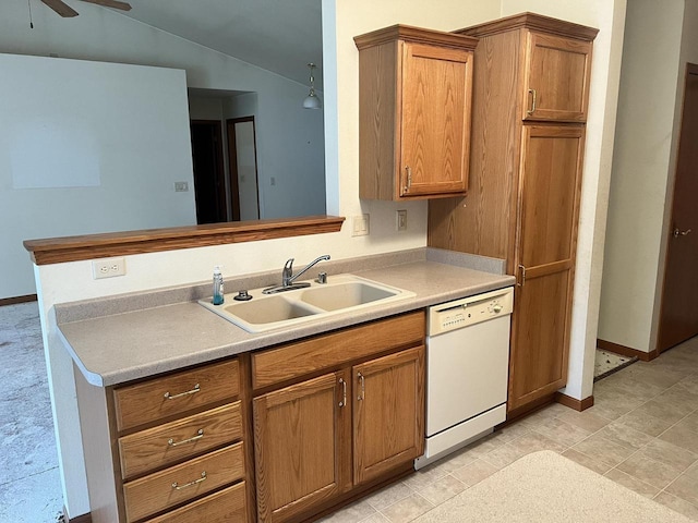 kitchen featuring brown cabinetry, vaulted ceiling, a sink, ceiling fan, and dishwasher