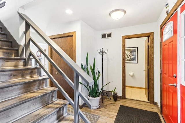 entrance foyer featuring visible vents, wood finished floors, recessed lighting, stairway, and baseboards