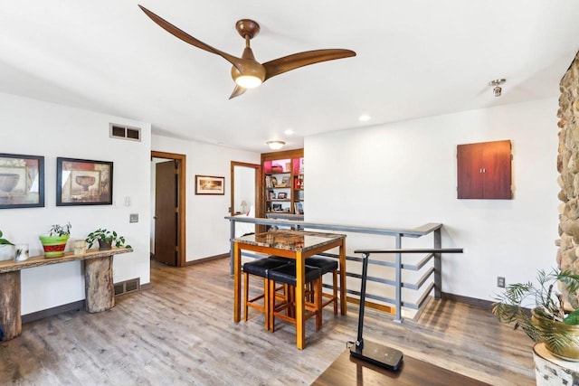 dining area featuring wood finished floors, visible vents, and ceiling fan