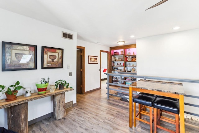 dining space featuring recessed lighting, visible vents, baseboards, and wood finished floors