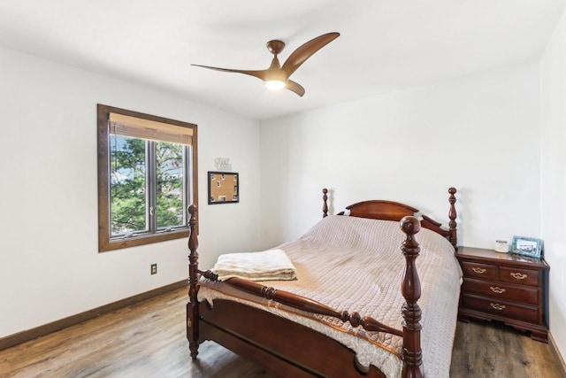 bedroom featuring wood finished floors, baseboards, and ceiling fan