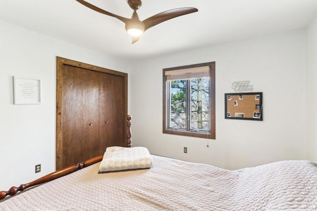 carpeted bedroom featuring a closet, baseboards, and a ceiling fan