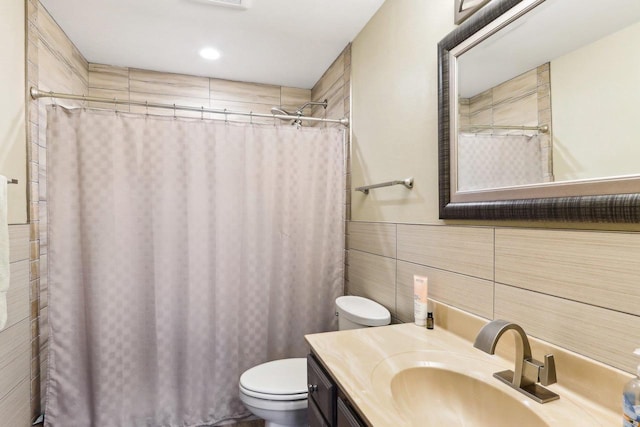 bathroom featuring vanity, tile walls, toilet, and a shower with curtain