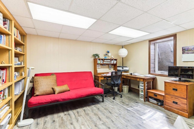 office space with wood finished floors and a paneled ceiling