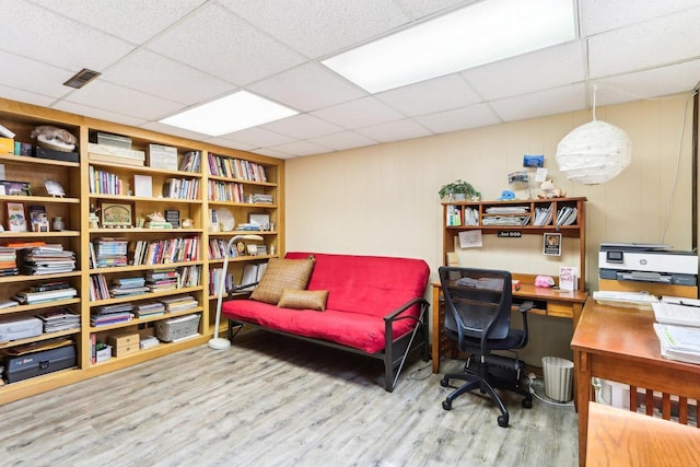 office area featuring a drop ceiling, visible vents, and wood finished floors