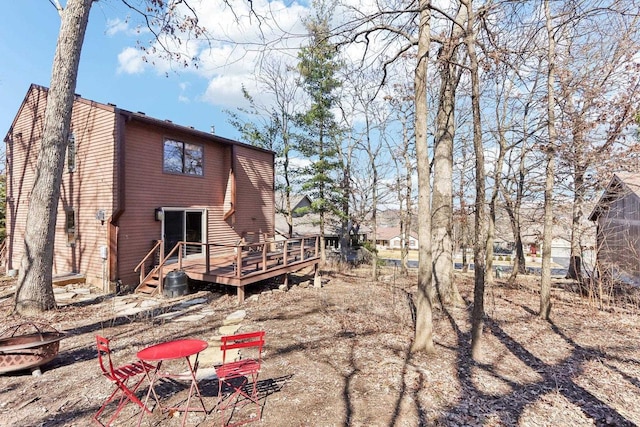 rear view of house with a wooden deck