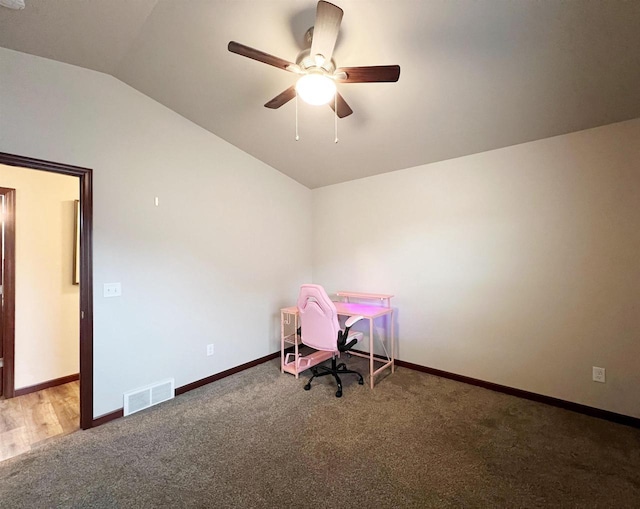 unfurnished office featuring baseboards, visible vents, a ceiling fan, lofted ceiling, and carpet