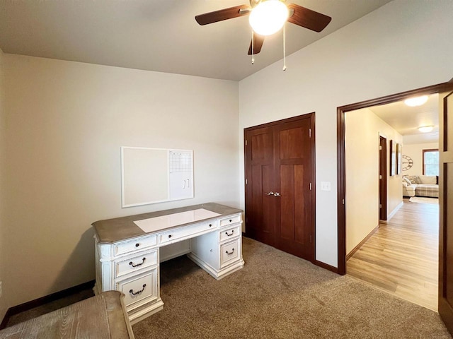 office space with light carpet, ceiling fan, and baseboards