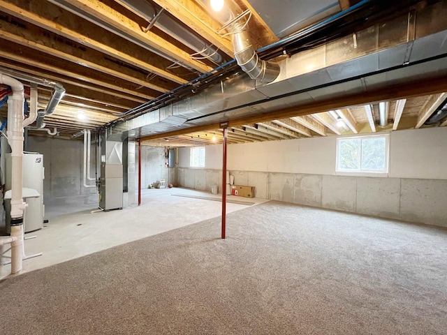 basement with water heater and heating unit