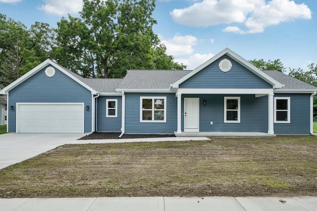 ranch-style house with a shingled roof, concrete driveway, an attached garage, covered porch, and a front lawn