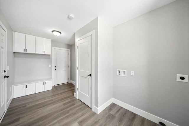 washroom with hookup for a washing machine, laundry area, wood finished floors, baseboards, and electric dryer hookup