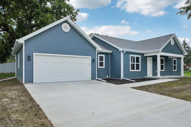 ranch-style house featuring a garage, concrete driveway, and roof with shingles