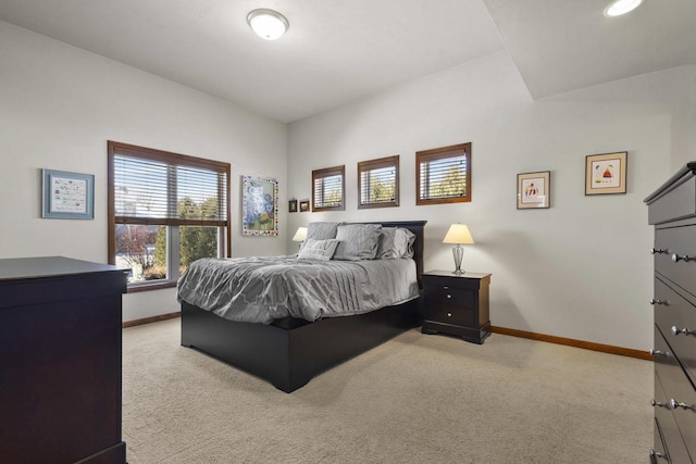 bedroom with light carpet and baseboards