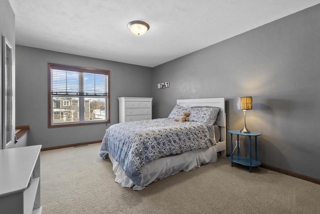 carpeted bedroom featuring baseboards