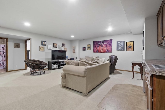 living area with light carpet, recessed lighting, and baseboards