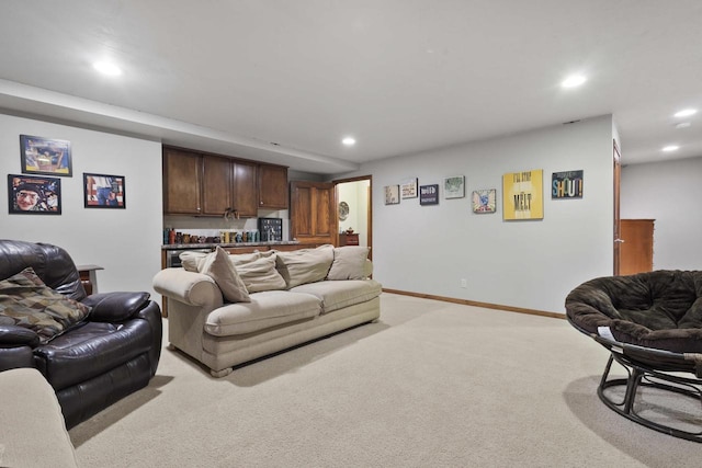 living area with baseboards, light colored carpet, and recessed lighting