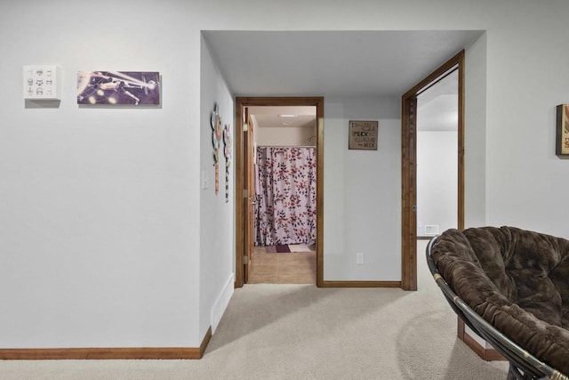 corridor featuring carpet and baseboards