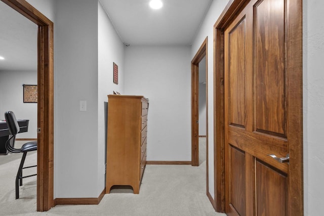 hall featuring light carpet and baseboards