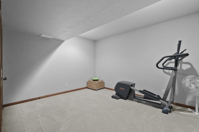 exercise room featuring carpet and baseboards