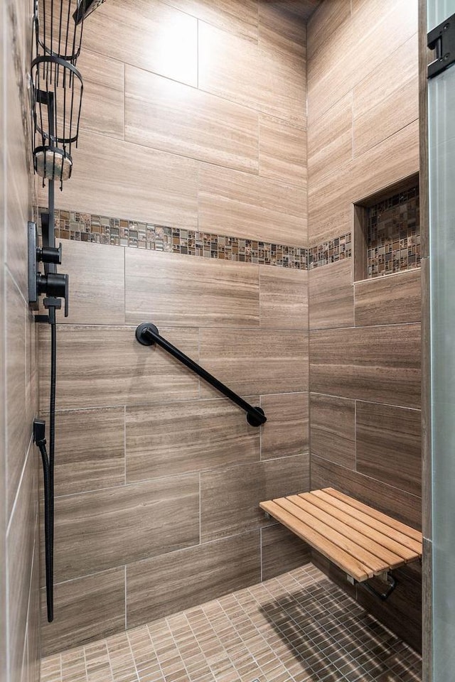 bathroom with a tile shower and a sauna