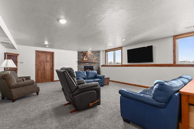 carpeted living area featuring baseboards, visible vents, a textured ceiling, and a stone fireplace