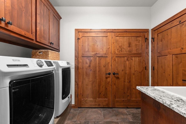 washroom with cabinet space and independent washer and dryer