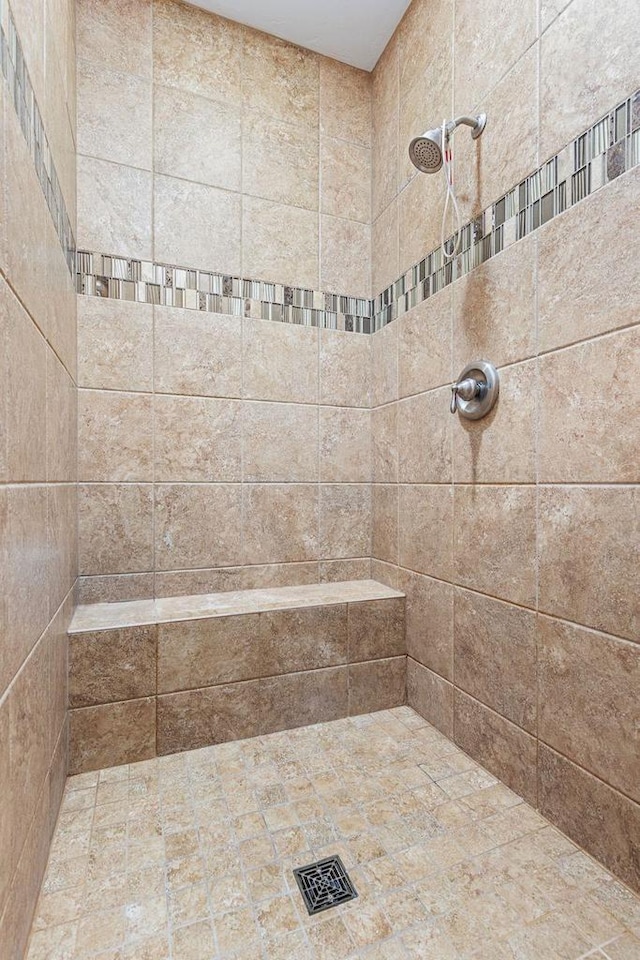 full bath with visible vents and a tile shower