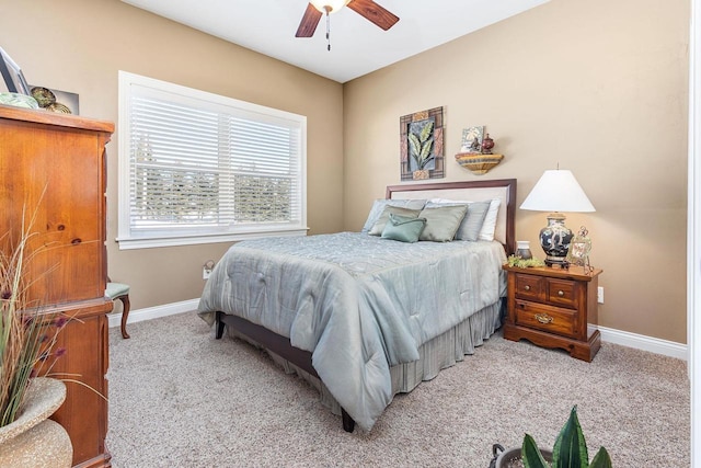 bedroom featuring a ceiling fan, light colored carpet, and baseboards