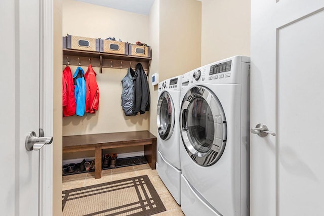 washroom featuring laundry area and washing machine and clothes dryer