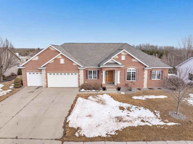 view of front of property with a garage, concrete driveway, brick siding, and roof with shingles