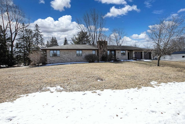 view of front of property featuring a garage and brick siding