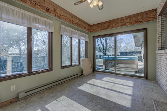 unfurnished sunroom featuring a baseboard radiator and a ceiling fan