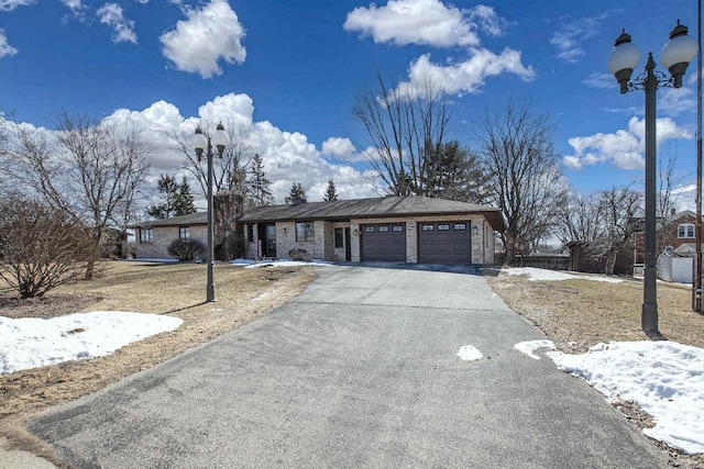 view of front of home with driveway and a garage