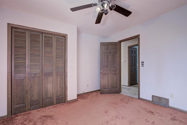 unfurnished bedroom with baseboards, visible vents, ceiling fan, carpet flooring, and a closet