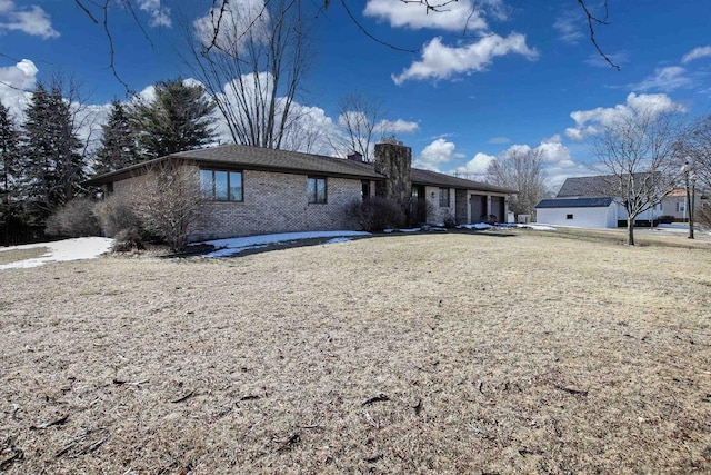 view of front of property with a front yard and brick siding